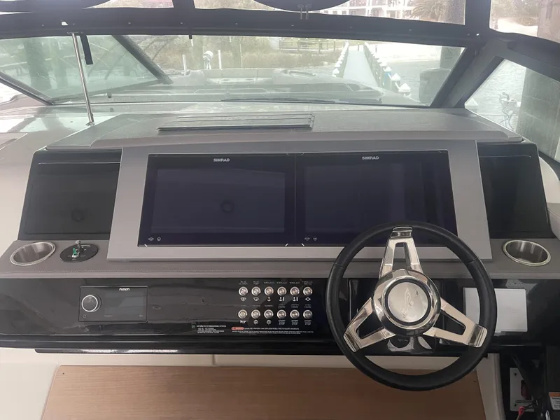 Slide: The Image of Control panel of 2022 Sea Ray SLX 400 boat with dual Simrad displays and steering wheel. - 5