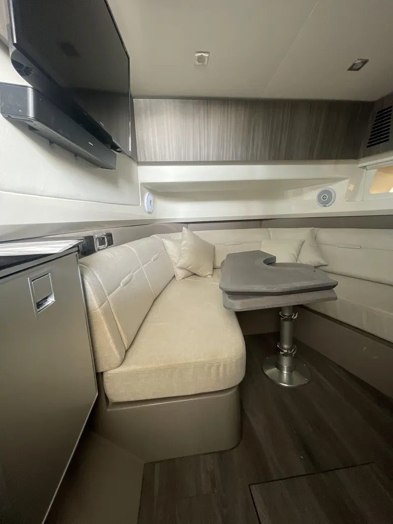 Slide: The Image of Interior of 2022 Sea Ray SLX 400 yacht with modern seating and table. - 9