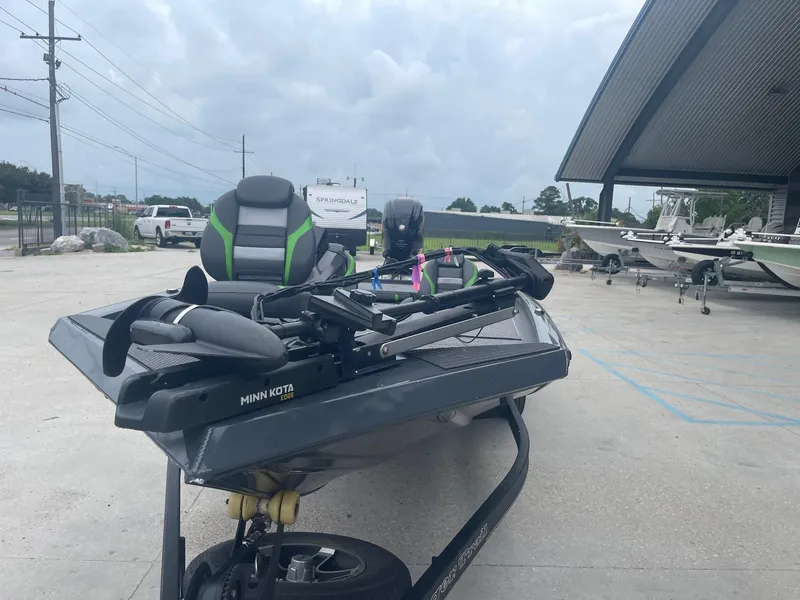 Slide: The Image of 2022 Ranger RT188 boat with Minn Kota motor in a parking lot. - 9