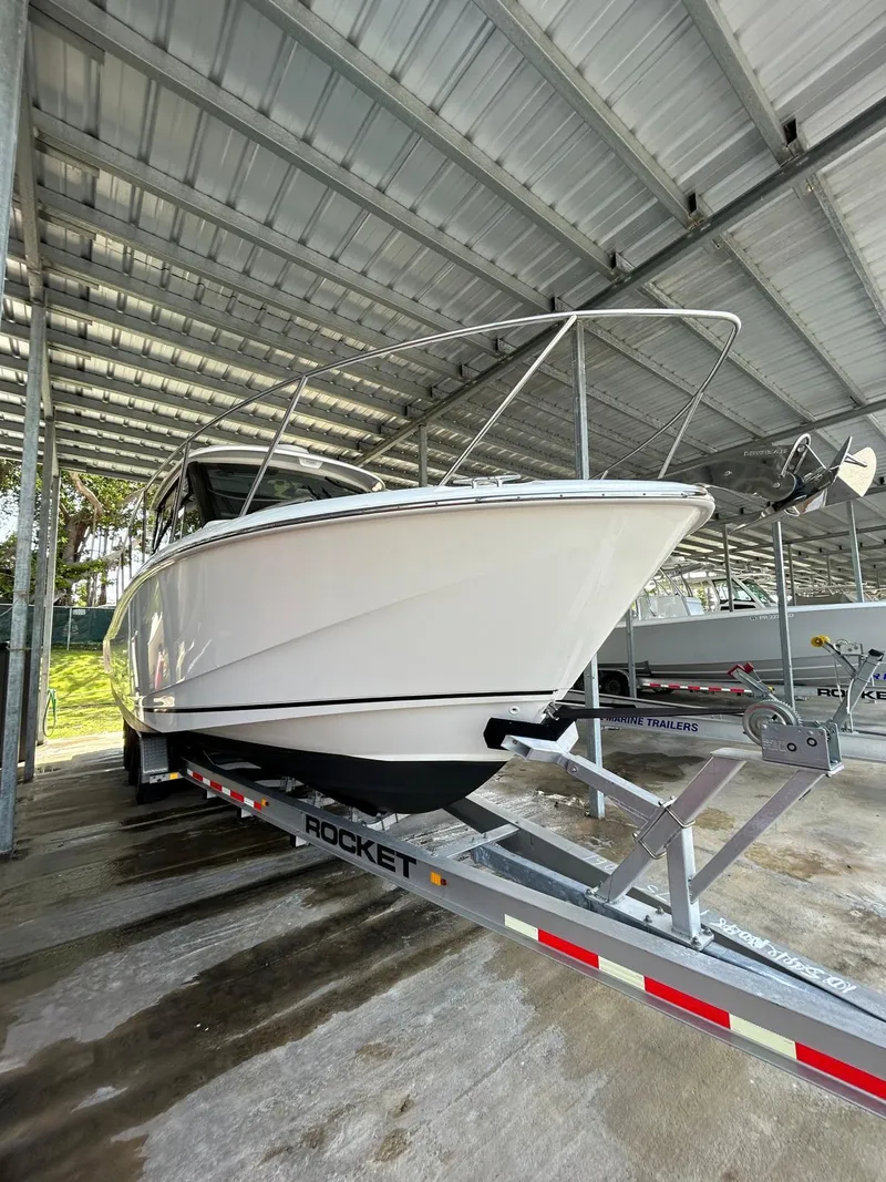 Slide: The Image of 2022 Boston Whaler 325 Conquest on trailer under covered storage. - 5