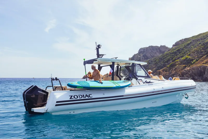 Slide: The Image of 2025 Zodiac X10CC boat on clear blue water near rocky coastline. - 11