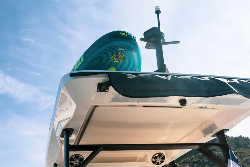 Slide: The Image of 2025 Zodiac X10CC boat, underside view with mounted equipment against a clear sky. - 13