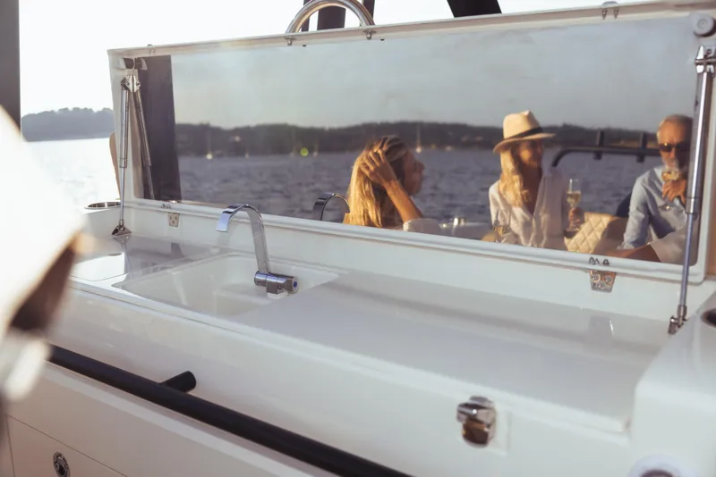 Slide: The Image of Zodiac X10CC 2025 boat with sleek sink, reflecting people enjoying a sunny day on the water. - 19