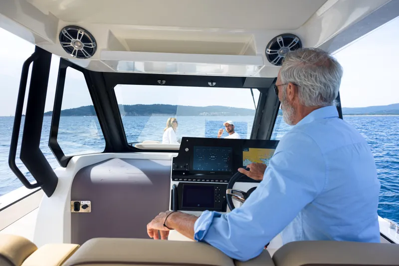 Slide: The Image of Man steering Zodiac X10CC boat on open water, 2025 model. - 20