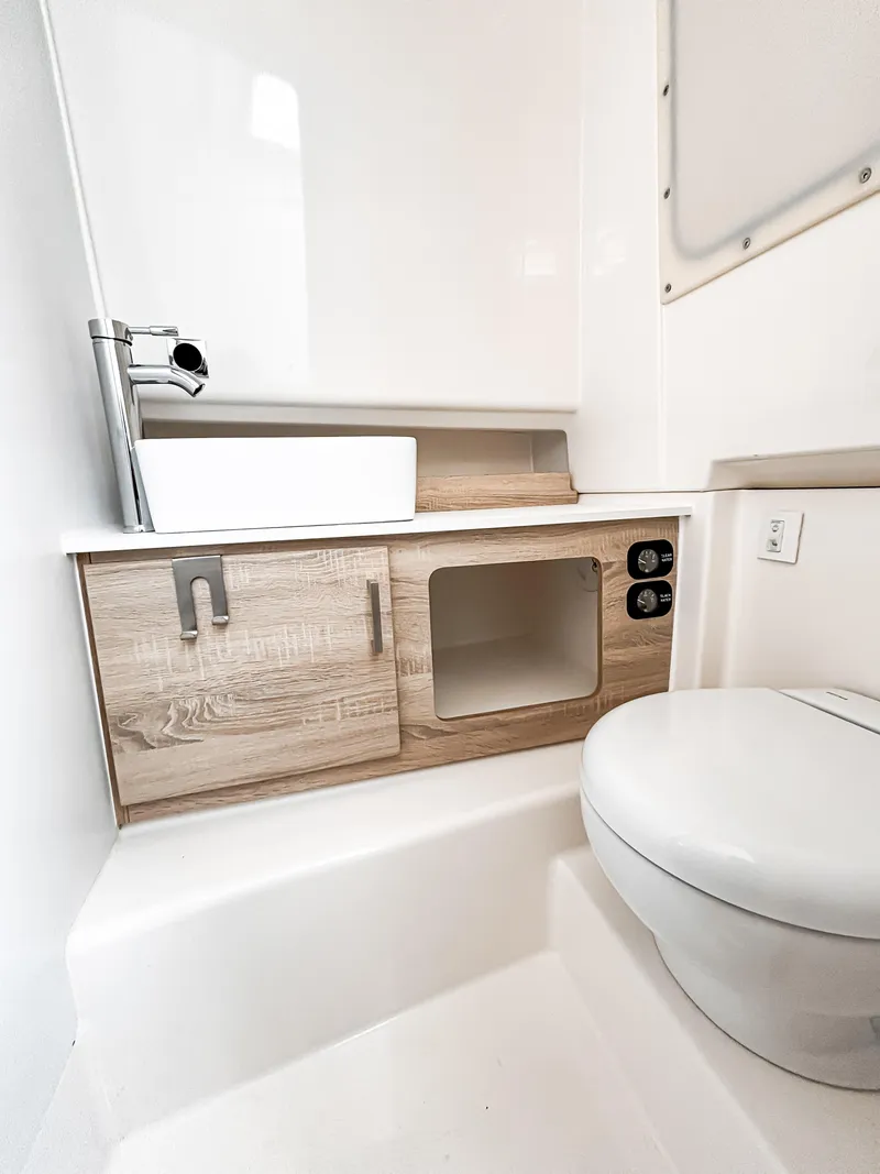 Slide: The Image of Modern bathroom in Zodiac X10CC 2025 boat, featuring sleek sink and compact toilet design. - 5