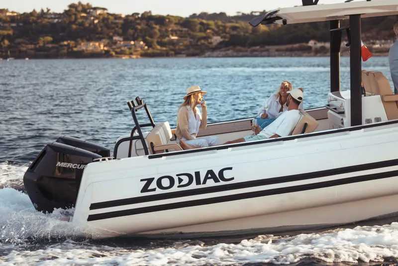 Slide: The Image of 2025 Zodiac X10CC boat cruising with passengers on a sunny day. - 7