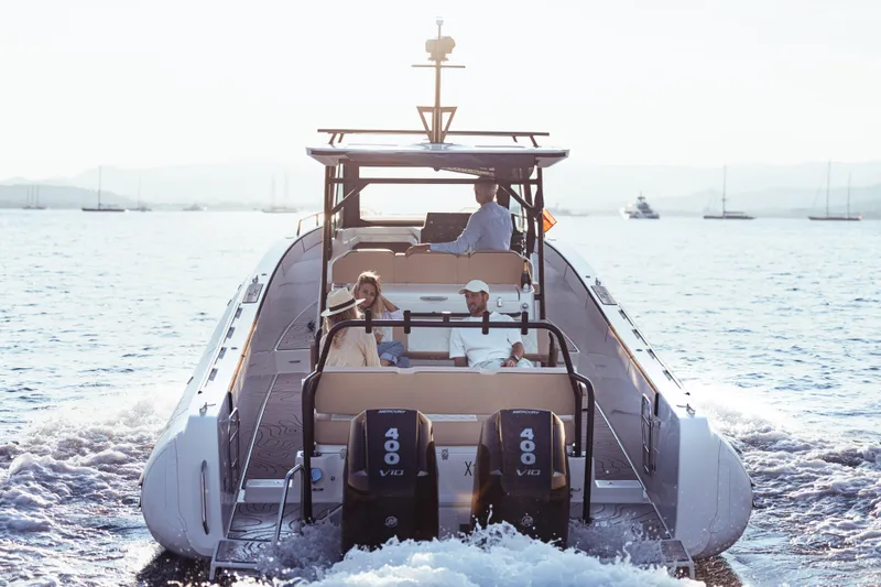 Slide: The Image of 2025 Zodiac X10CC boat cruising on open water with passengers enjoying the ride. - 8