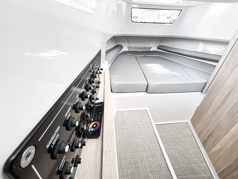 Slide: The Image of 2025 Zodiac X10CC cabin interior with control panel and cushioned seating area. - 9