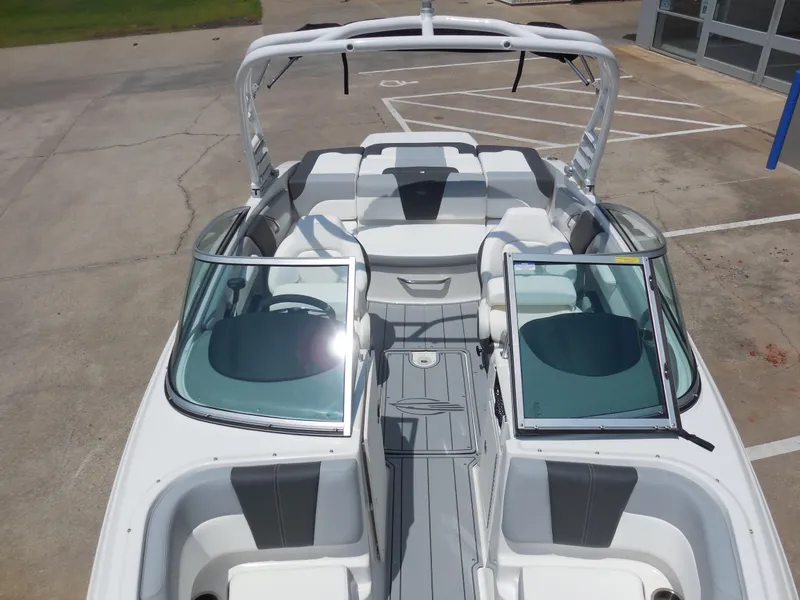 Slide: The Image of 2024 Chaparral 21 SSi boat interior with open windshield and seating. - 11