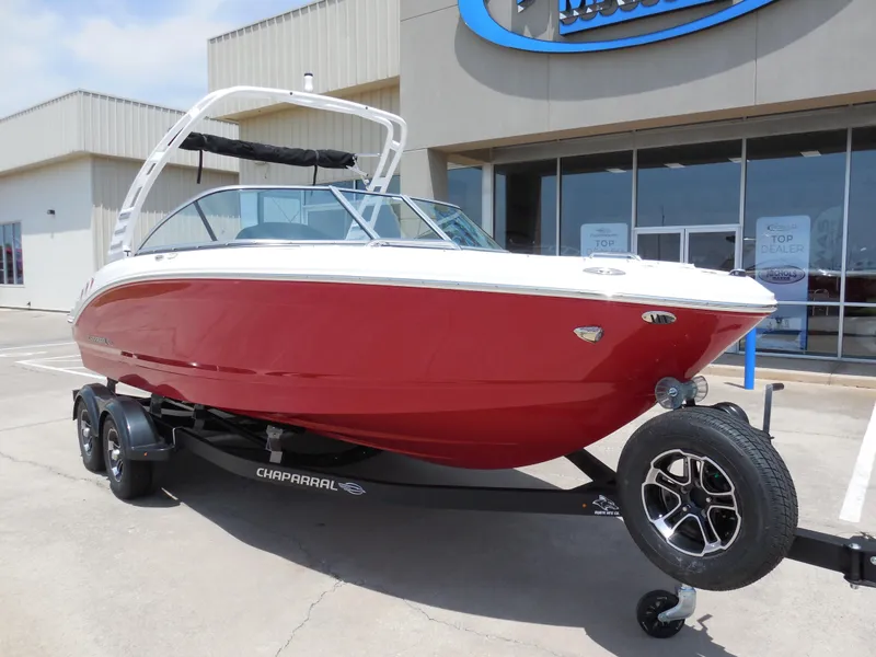 Slide: The Image of 2024 Chaparral 21 SSi boat in red on a trailer outside a dealership. - 2