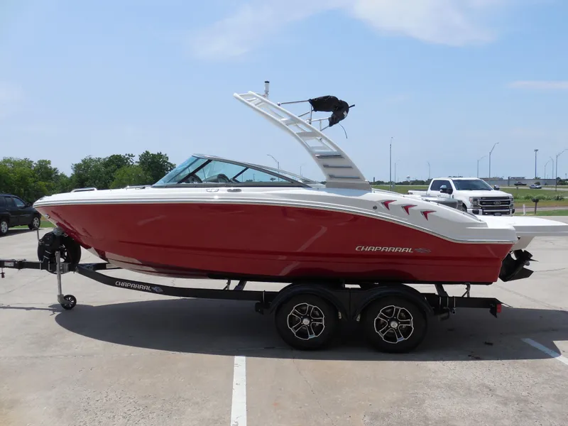 Slide: The Image of 2024 Chaparral 21 SSi boat in red and white on a trailer. - 5