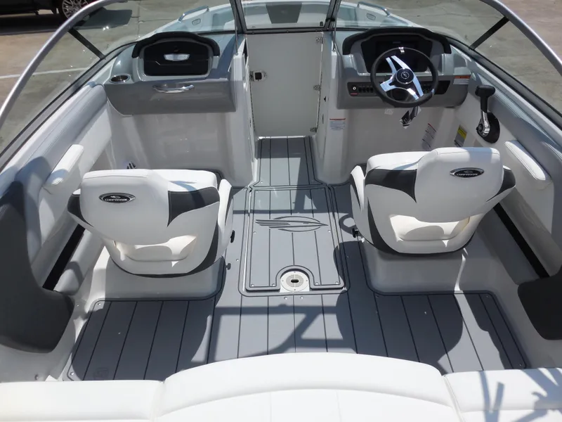 Slide: The Image of 2024 Chaparral 21 SSi boat interior with dual captain's chairs and modern dashboard. - 7