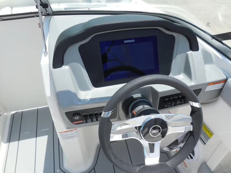 Slide: The Image of 2024 Chaparral 21 SSi boat dashboard with steering wheel and digital display. - 8