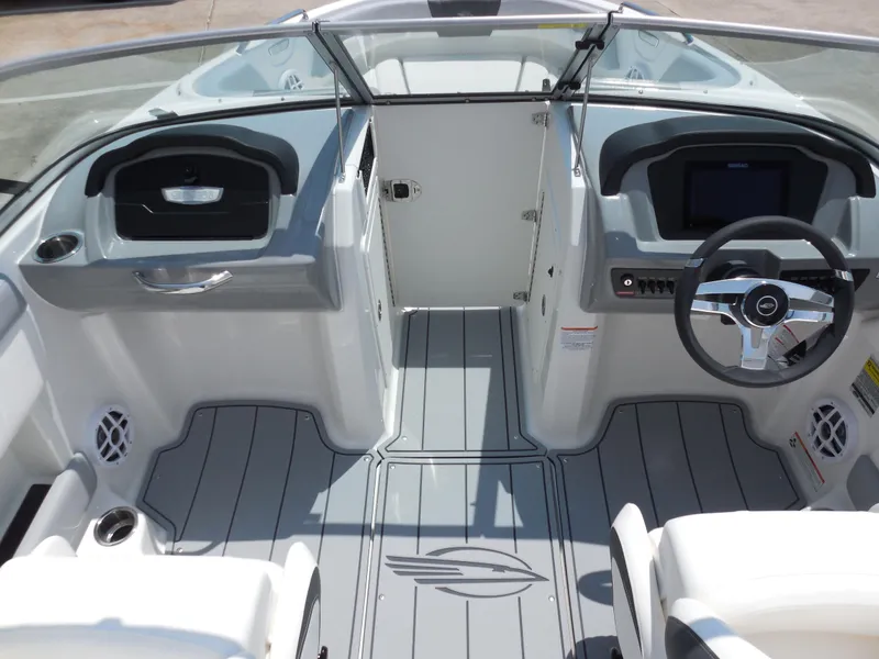 Slide: The Image of 2024 Chaparral 21 SSi boat interior with modern dashboard and seating. - 9