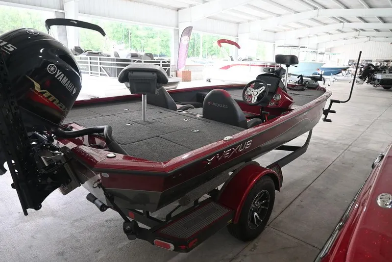 Slide: The Image of 2021 Vexus AVX1880 fishing boat with Yamaha motor in a covered storage area. - 3