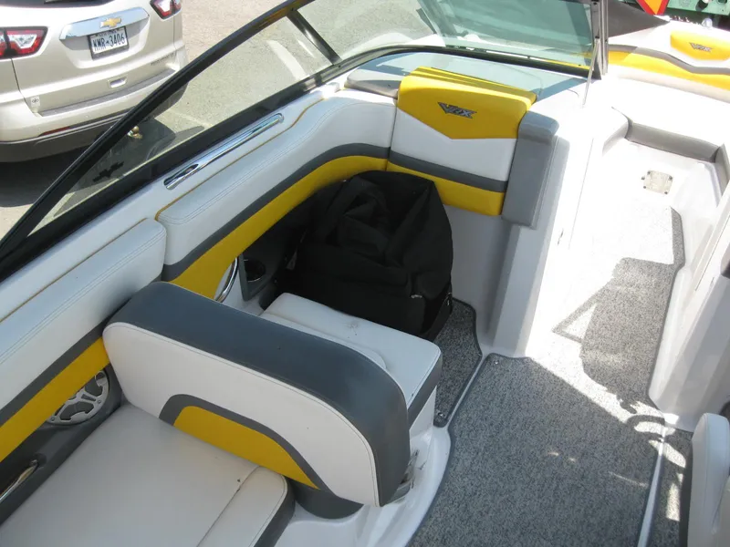 Slide: The Image of Interior of a 2015 Chaparral 203 Vortex VRX boat with yellow and gray seating. - 10