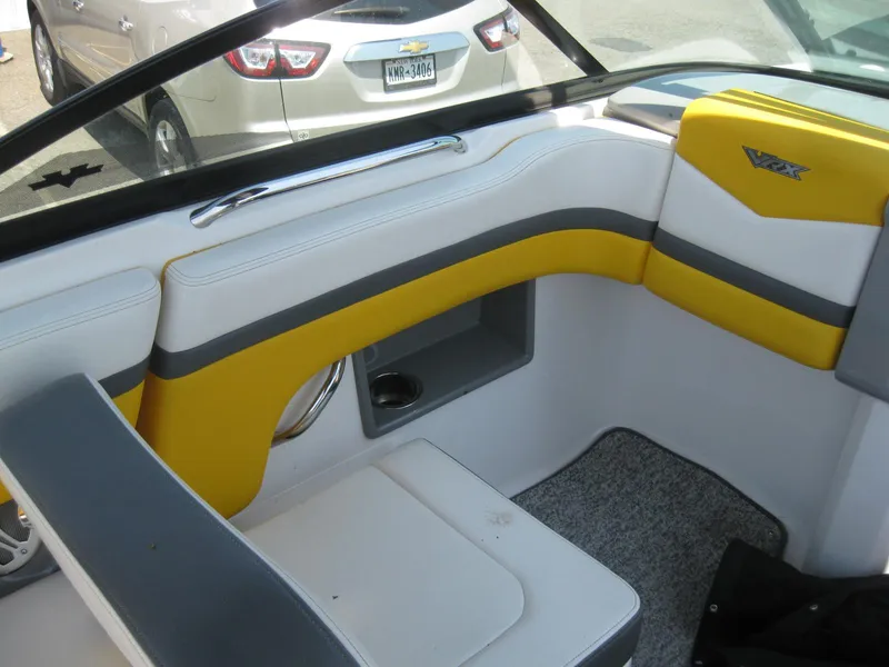 Slide: The Image of Interior of a 2015 Chaparral 203 Vortex VRX boat with yellow and gray seating. - 15