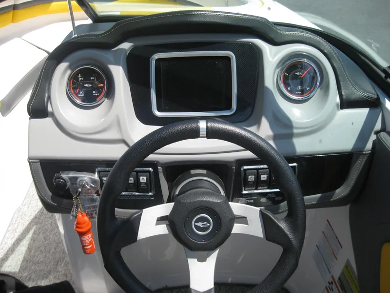 Slide: The Image of 2015 Chaparral 203 Vortex VRX boat dashboard with steering wheel and gauges. - 16