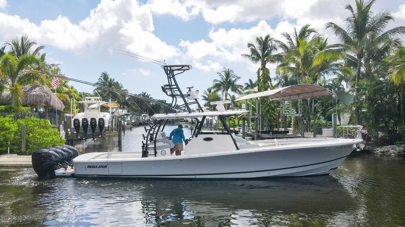 The Image of 2020 Regulator 41 boat docked in a tropical marina with palm trees. - 0