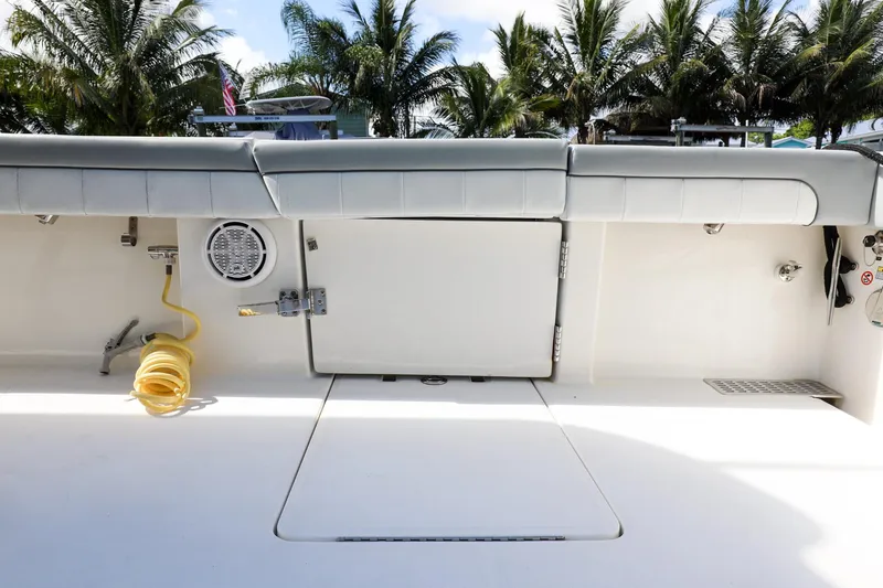 Slide: The Image of 2020 Regulator 41 boat deck with storage compartments and coiled hose. - 17