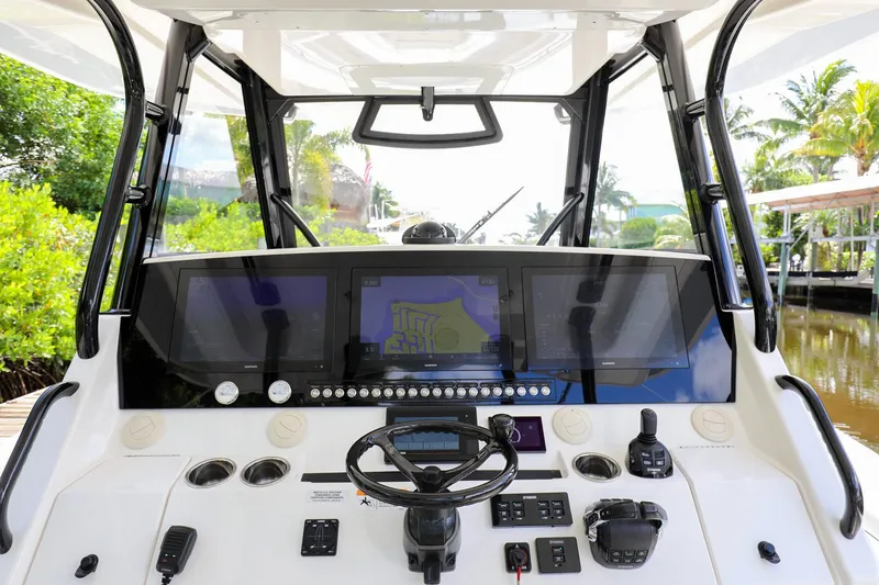 Slide: The Image of 2020 Regulator 41 boat helm with advanced navigation controls and screens. - 19