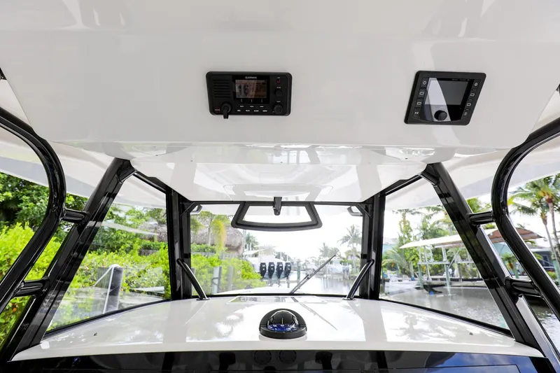Slide: The Image of 2020 Regulator 41 boat helm station with electronics and overhead console. - 21