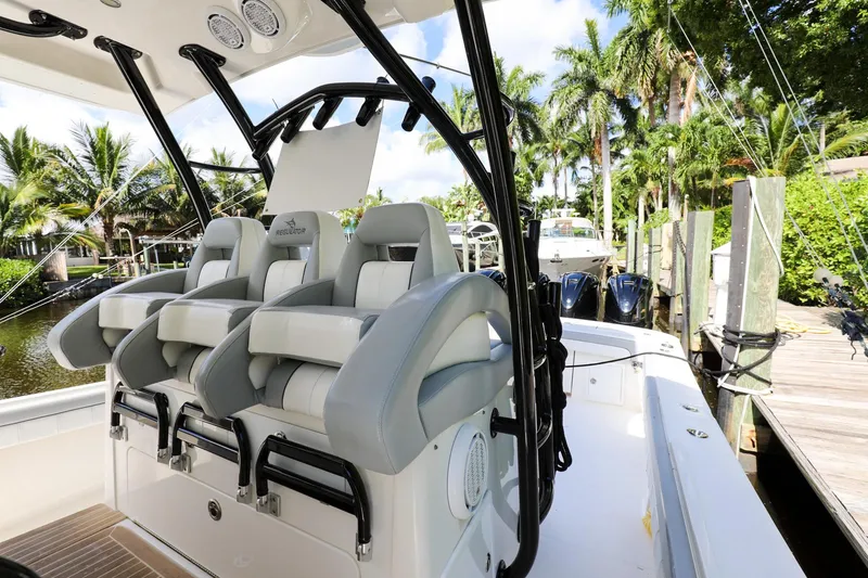 Slide: The Image of 2020 Regulator 41 boat with luxurious seating and modern design at a dock. - 23