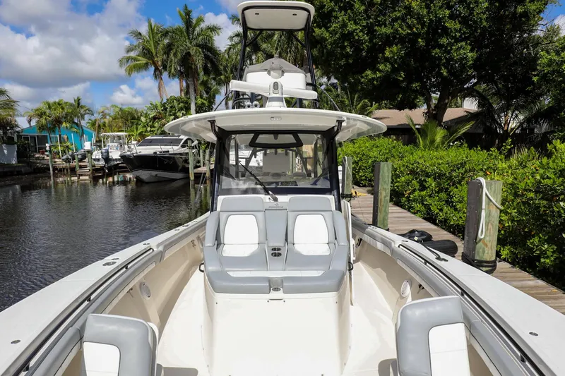 Slide: The Image of 2020 Regulator 41 boat docked in a scenic marina with lush greenery. - 36