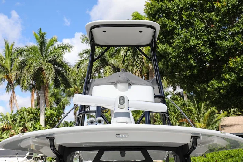 Slide: The Image of 2020 Regulator 41 boat with radar and T-top, surrounded by palm trees. - 38