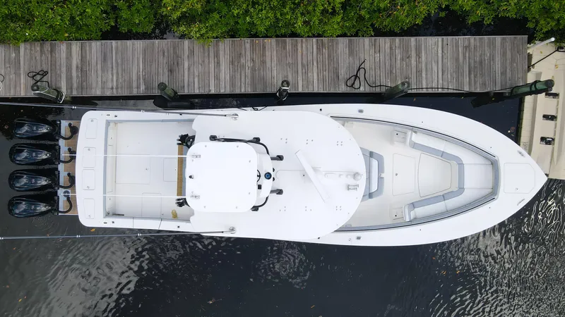 Slide: The Image of Aerial view of a 2020 Regulator 41 boat docked by a wooden pier. - 4
