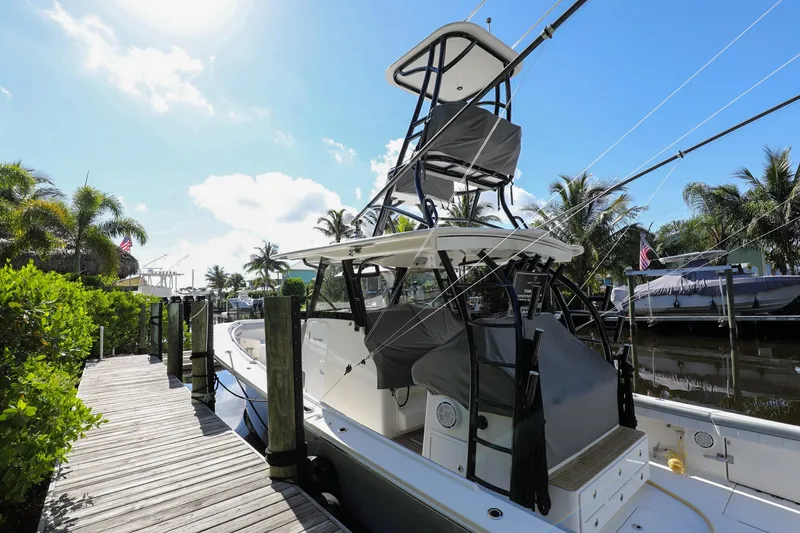 Slide: The Image of 2020 Regulator 41 boat docked at a marina with palm trees in the background. - 42