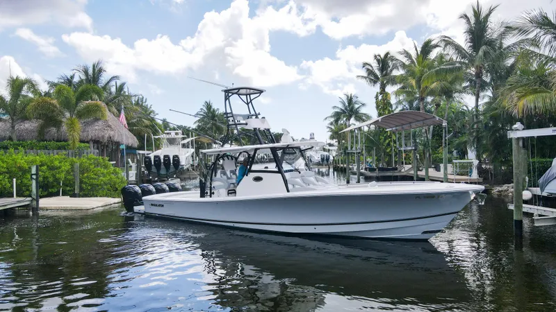 Slide: The Image of 2020 Regulator 41 boat docked in a tropical marina with palm trees. - 5