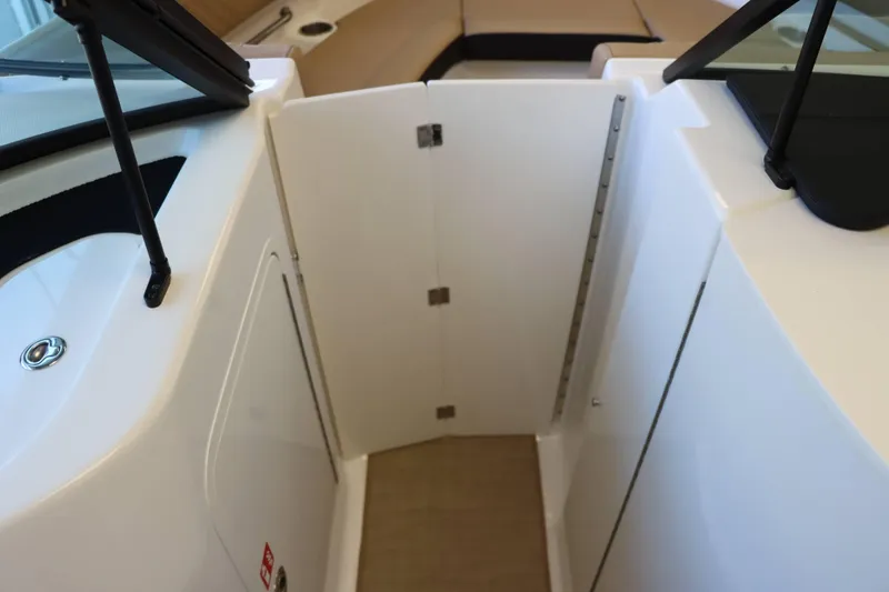 Slide: The Image of 2025 Sea Ray 250SDX boat interior with white door and sleek design. - 12