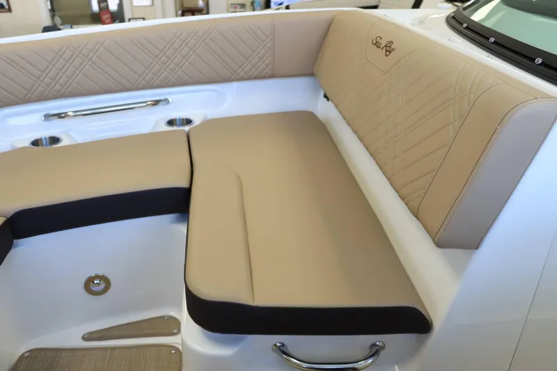 Slide: The Image of Luxurious seating on 2025 Sea Ray 250SDX boat, featuring beige upholstery and stainless steel accents. - 16
