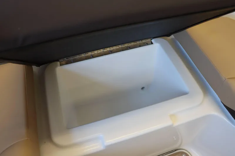 Slide: The Image of Open storage compartment on 2025 Sea Ray 250SDX boat. - 18