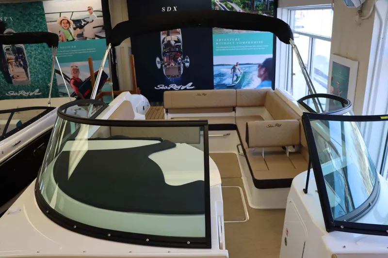 Slide: The Image of 2025 Sea Ray 250SDX boat interior with beige seating and sleek design. - 20