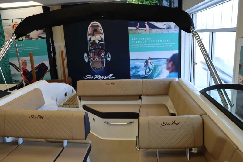 Slide: The Image of 2025 Sea Ray 250SDX boat interior with beige seating and promotional display. - 21