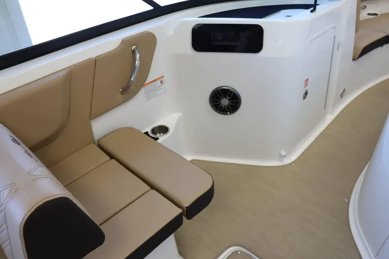 Slide: The Image of 2025 Sea Ray 250SDX boat interior with tan seating and speaker system. - 23