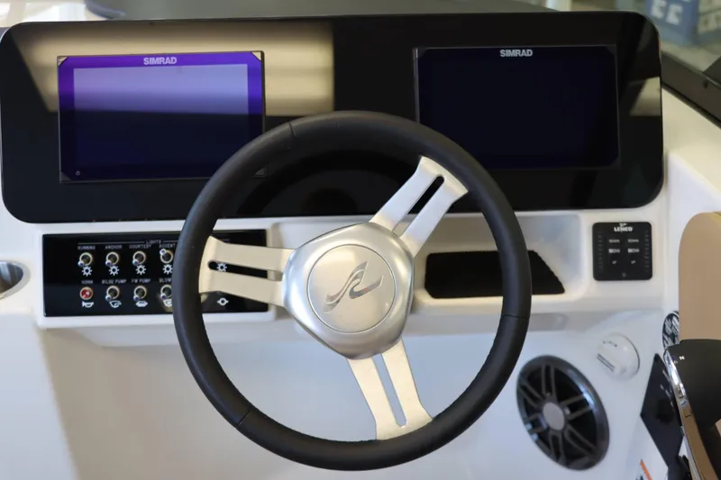 Slide: The Image of 2025 Sea Ray 250SDX dashboard with steering wheel and dual Simrad displays. - 24