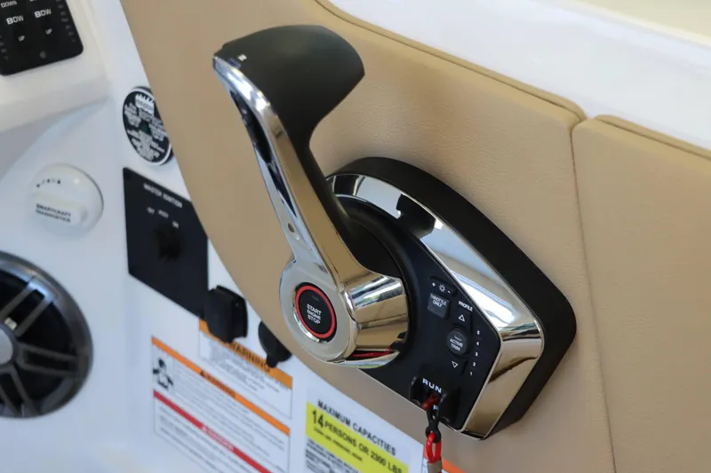 Slide: The Image of Control panel of 2025 Sea Ray 250SDX boat with start-stop button and throttle lever. - 25