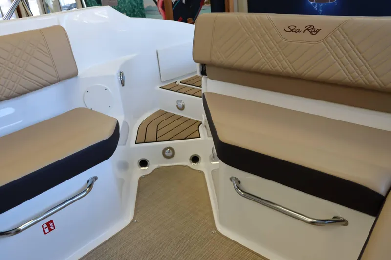 Slide: The Image of 2025 Sea Ray 250SDX boat interior with beige seating and stainless steel handles. - 27