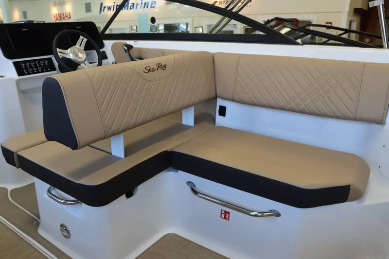 Slide: The Image of 2025 Sea Ray 250SDX boat interior with beige seating and steering wheel. - 28