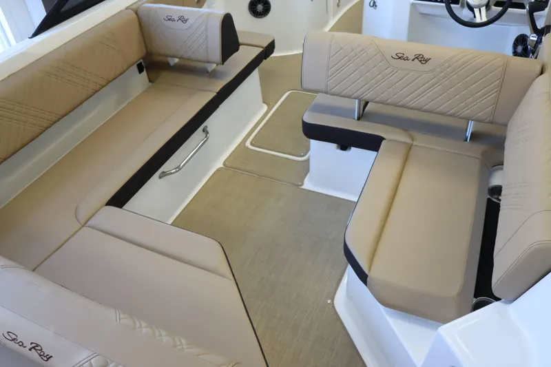 Slide: The Image of 2025 Sea Ray 250SDX boat interior with beige seating and elegant design. - 31