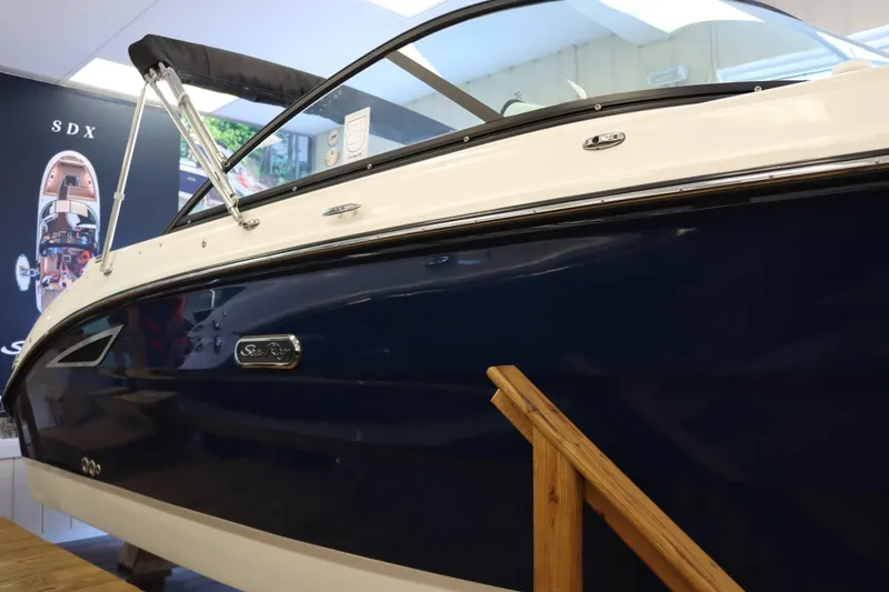 Slide: The Image of 2025 Sea Ray 250SDX boat displayed indoors, showcasing sleek design and modern features. - 4