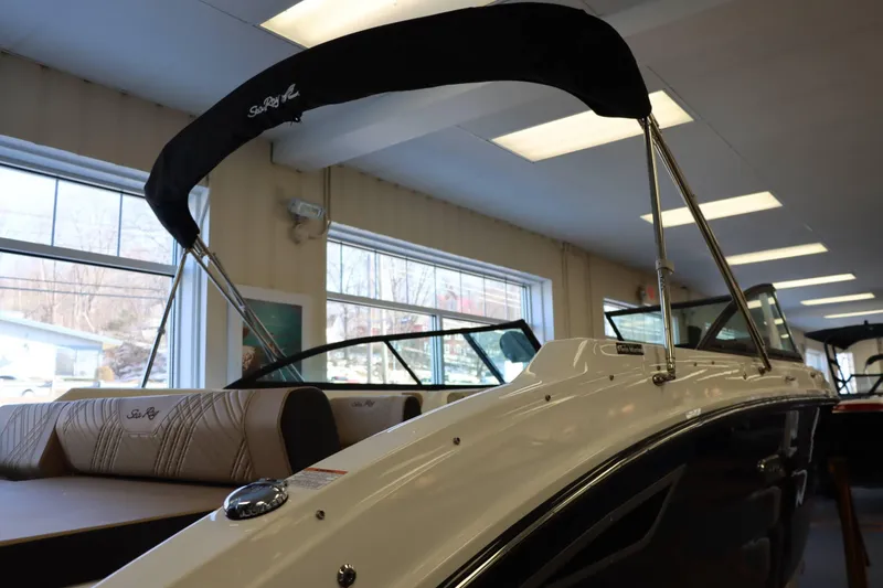 Slide: The Image of 2025 Sea Ray 250SDX boat interior with bimini top in showroom. - 5