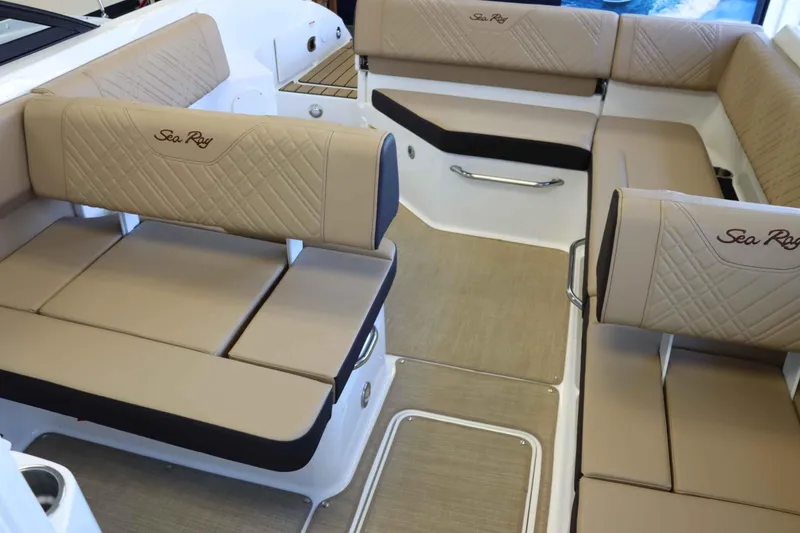 Slide: The Image of 2025 Sea Ray 250SDX boat interior with beige seating and elegant design. - 6