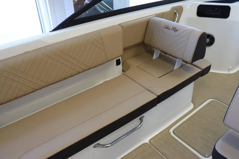 Slide: The Image of 2025 Sea Ray 250SDX boat interior with beige seating and elegant stitching. - 7
