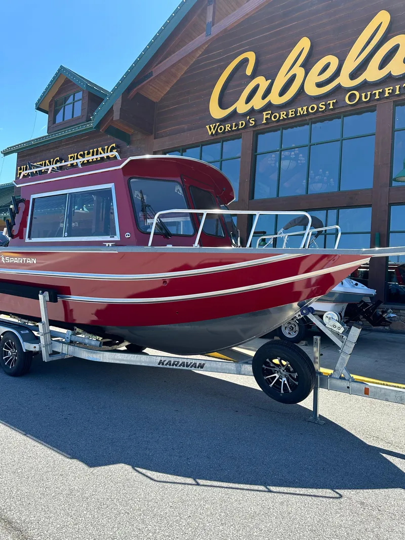 Slide: The Image of 2024 Spartan 220 Maximus boat on trailer outside Cabela's store. - 10