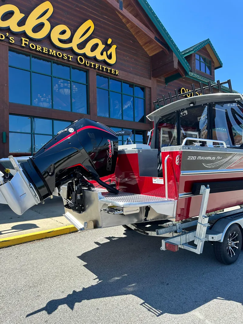 Slide: The Image of 2024 Spartan 220 Maximus boat on trailer outside Cabela's store. - 12