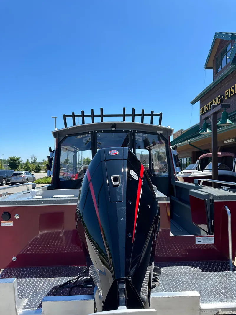 Slide: The Image of Alt text: 2024 Spartan 220 Maximus boat on display outside a store. - 13